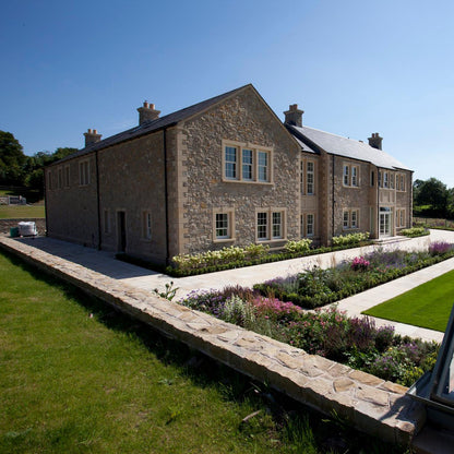 Large stone house with Sandstone Window Surrounds and well maintained patio and garden. 