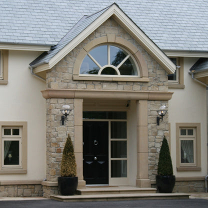 Stone entrance with bespoke semi circle window surrounds. 