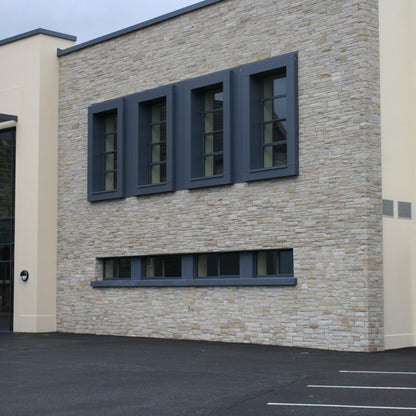 Large building with stonework completed in Sawn Bed Sandstone Machined.