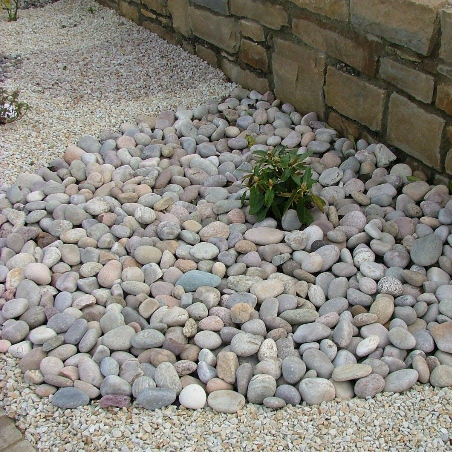 Garden with wall featuring a semi circle of Scottish Beach Pebbles. 