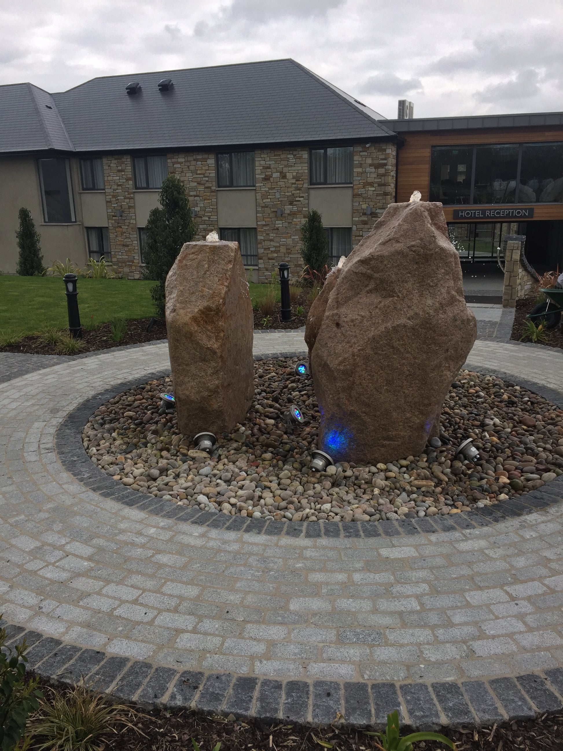 Garden feature showcasing three large sandstone monoliths on top of Scottish Beach Pebbles. 