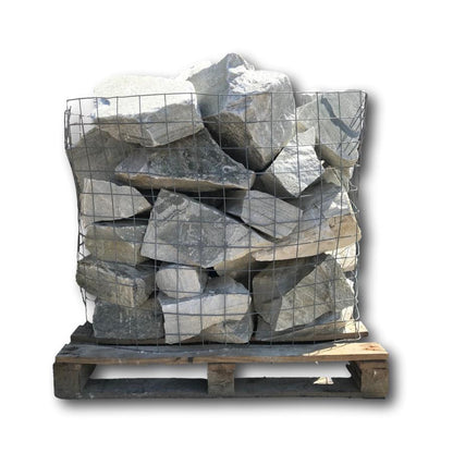Cage containing Silver Donegal Quartzite Rockery Stones against a white background. 