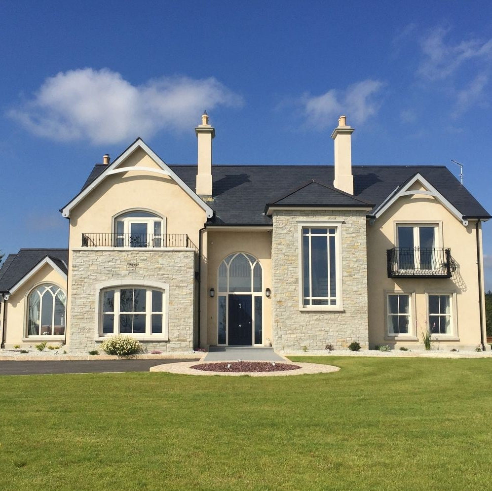 Modern new build with a natural stone façade completed using 30mm Silver Donegal Quartzite Stoneer Cladding.