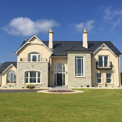 Modern new build with a natural stone façade completed using 30mm Silver Donegal Quartzite Stoneer Cladding.