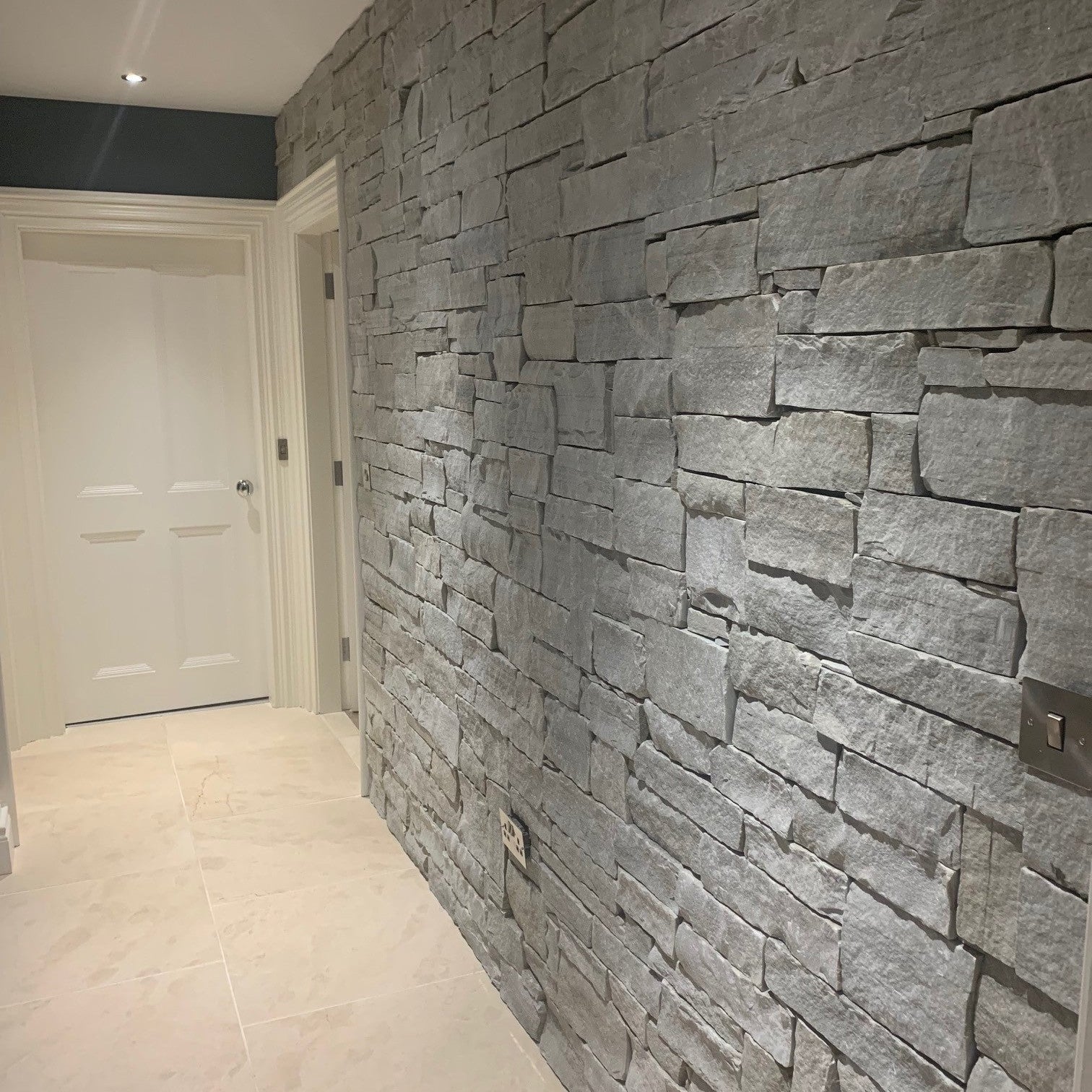 Internal stone feature wall completed using Silver Donegal Quartzite Stoneer Cladding.