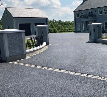 Bespoke Apex Silver Granite Pillar Capping on driveway with house and garage in the background. 