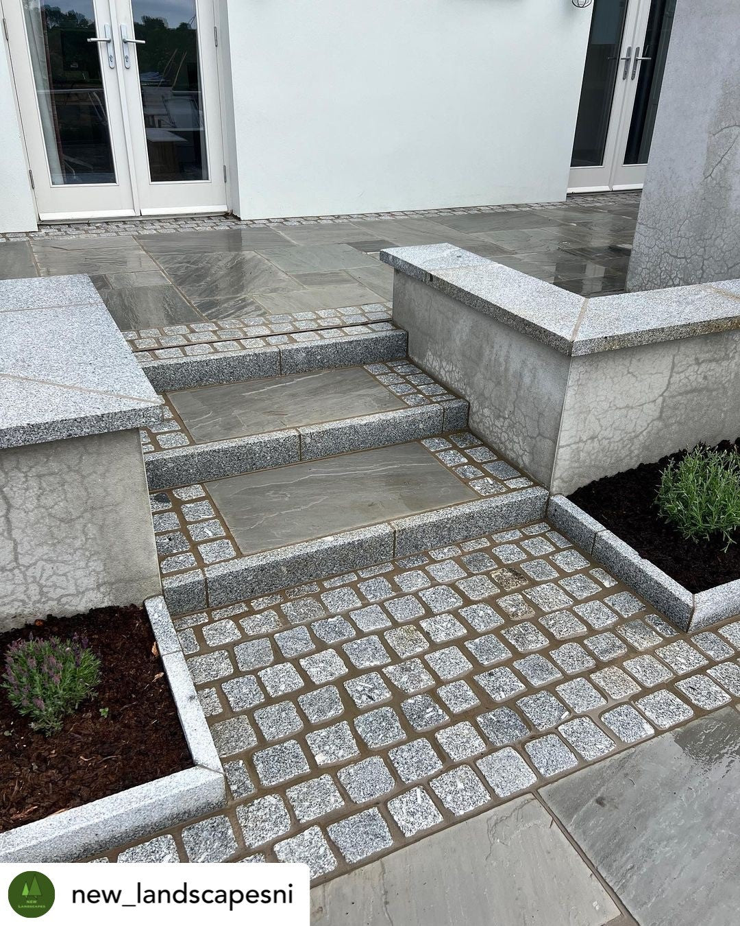 Paved pathway with steps leading up to a building entrance. Patio walls completed using Silver Granite Wall Capping