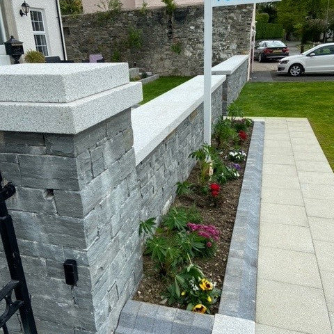 Neatly constructed stone wall with Silver Granite Wall Capping. 