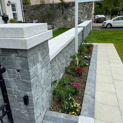 Neatly constructed stone wall with Silver Granite Wall Capping. 