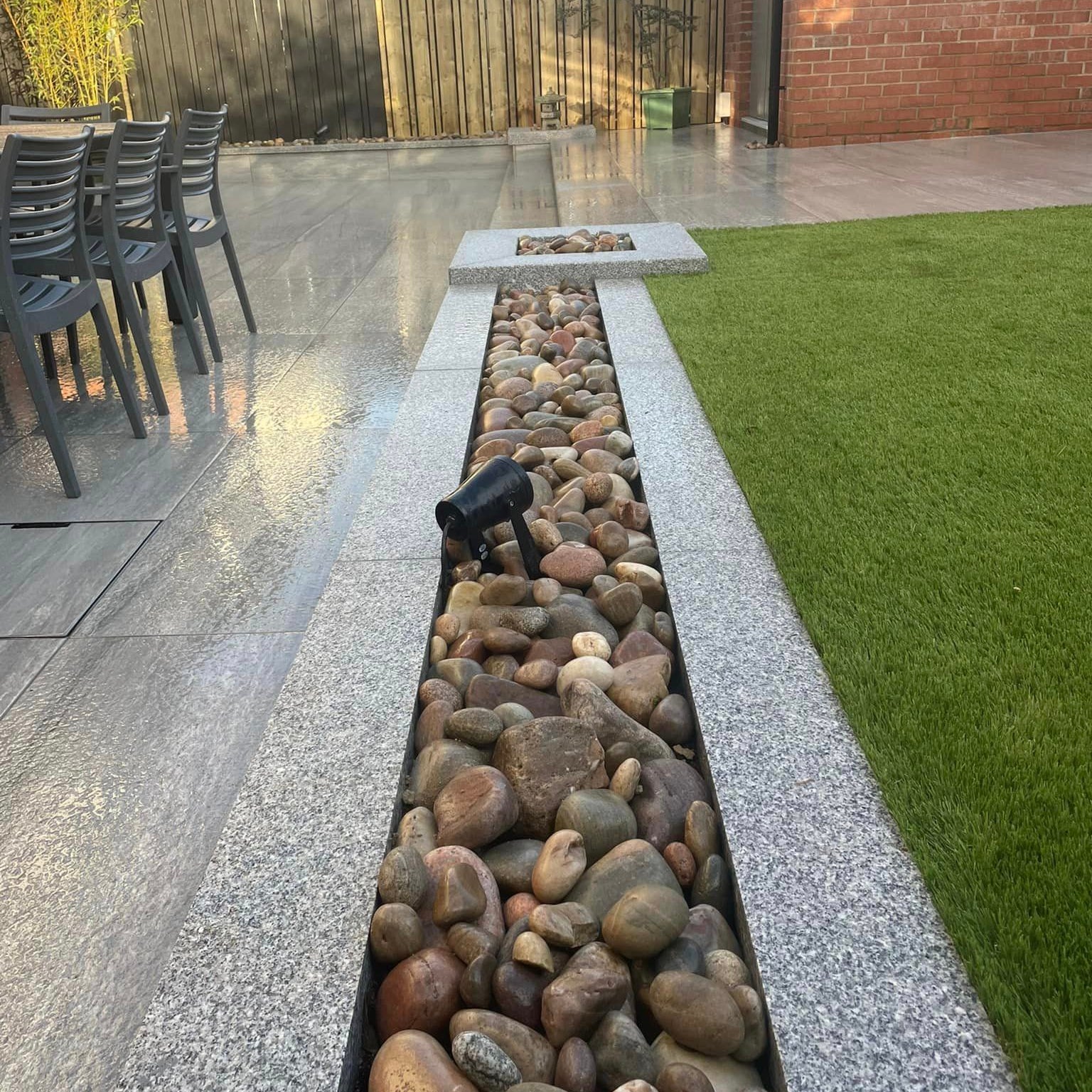 Low patio wall with Silver Granite Wall Capping and Scottish Beach Pebbles 