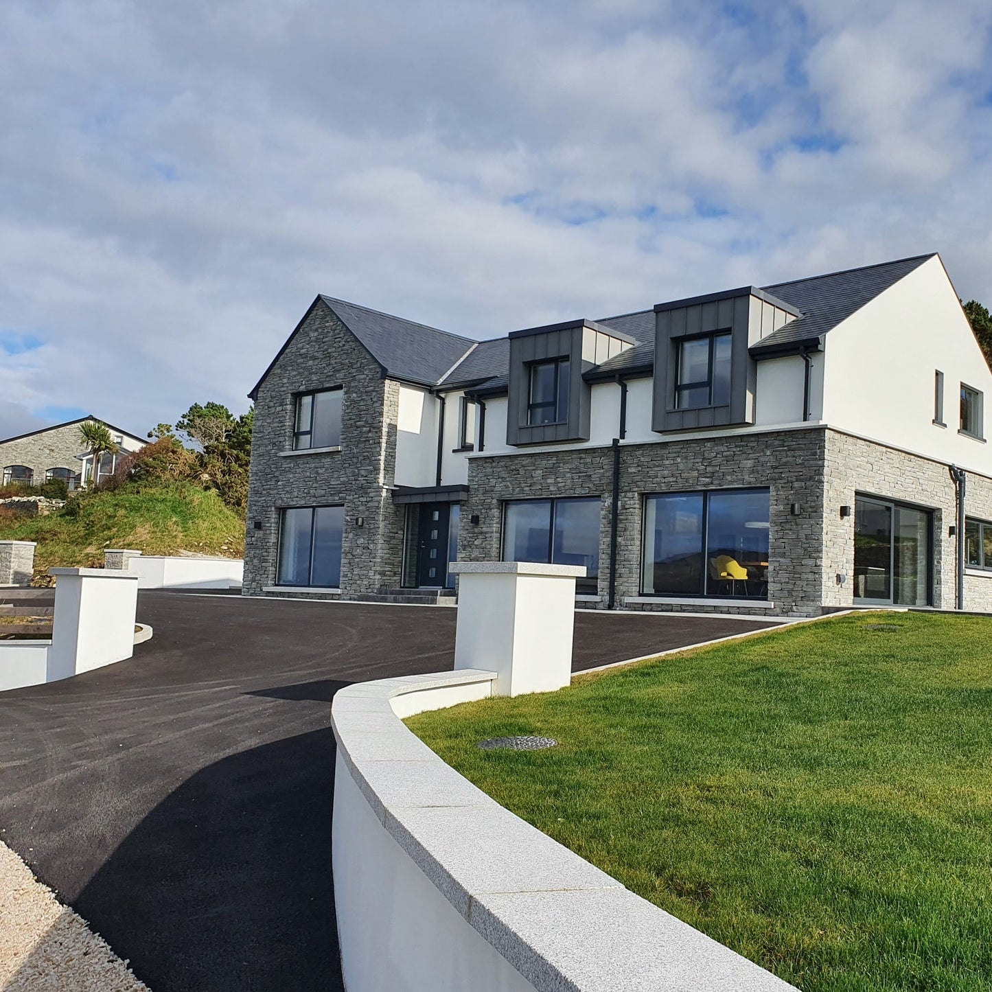 Modern house with curved boundary walls completed with Silver Granite Wall Capping and Sills. 