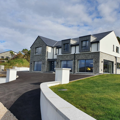 Modern house with curved boundary walls completed with Silver Granite Wall Capping and Sills. 