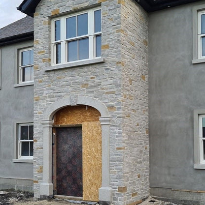 House exterior with stone façade and bespoke silver granite door surround recently added. 