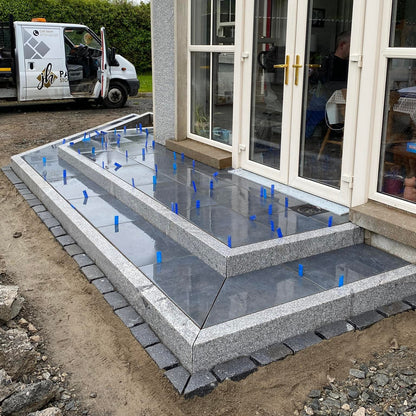 Porcelain steps finished with Silver Granite Kerbing with a blasted finish. 