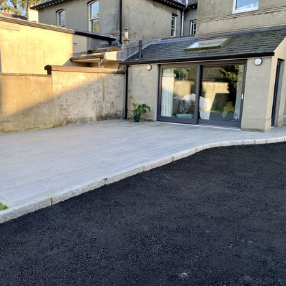 Porcelain patio bordered with Silver Granite Kerbing with a pineapple finish. 