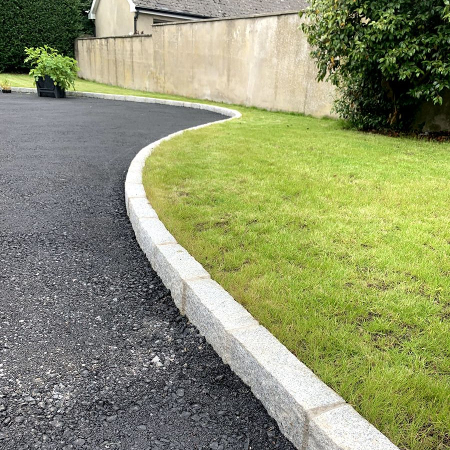 Driveway edging featuring Silver Granite Kerbs with pineapple finish. 