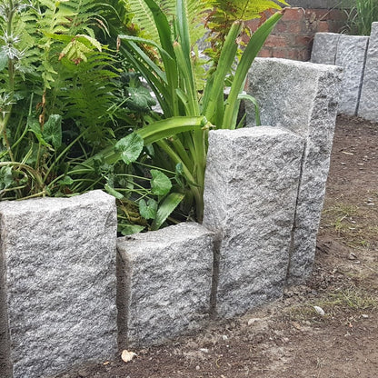 Planting beds surrounded by Silver Granite Kerbs with a pineapple finish. 