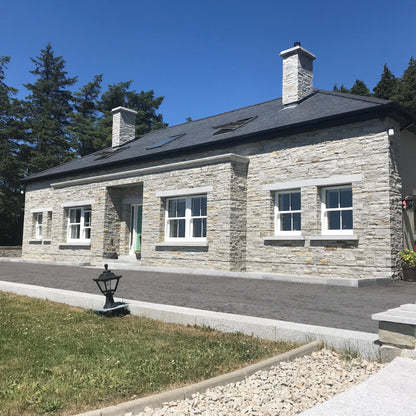 Stone house featuring bespoke silver granite window lintels and sills. 