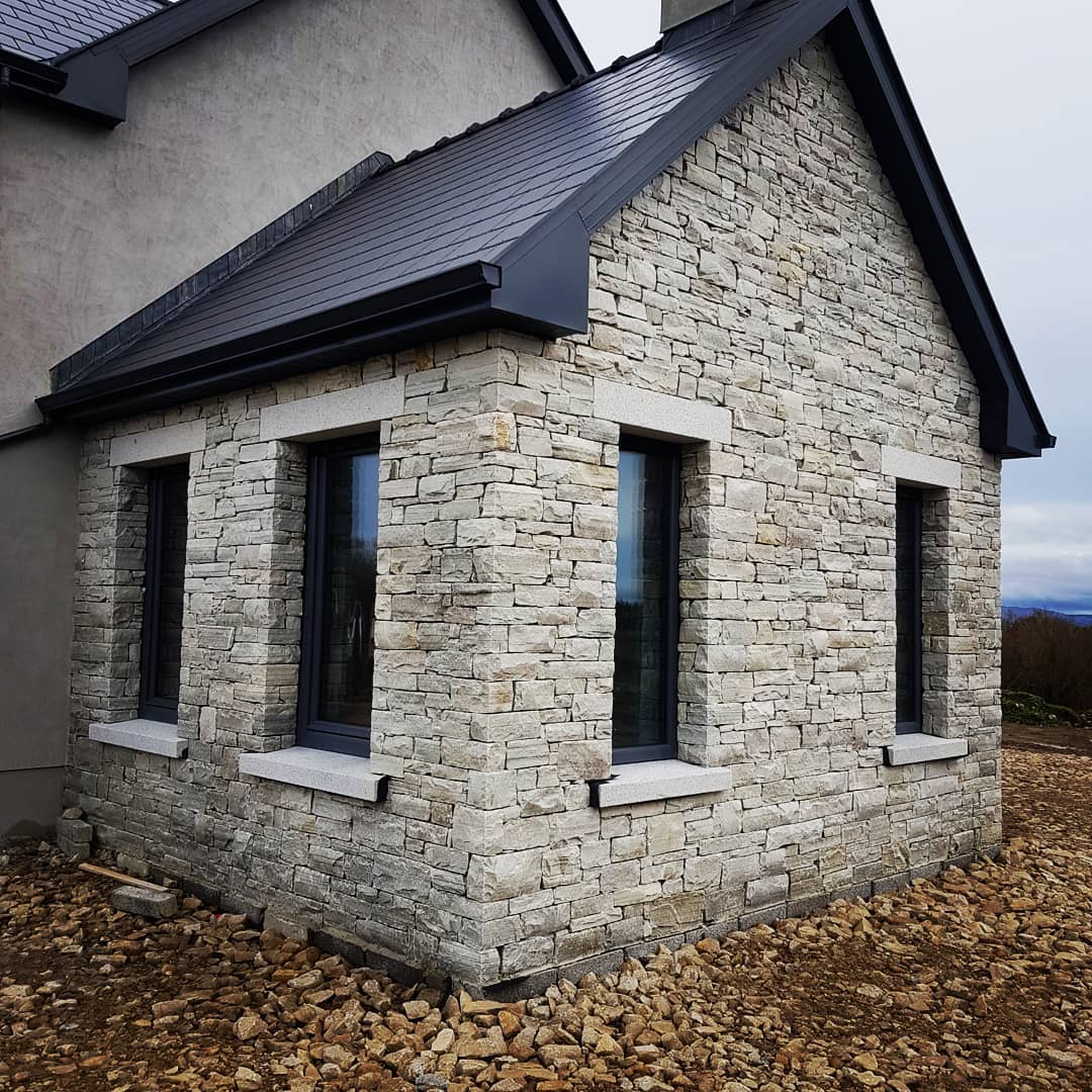 Stone porch with bespoke silver granite lintels and sills. 