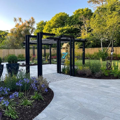 Beautiful garden and patio design showcasing Silver Granite Paving in 600x300mm size. 
