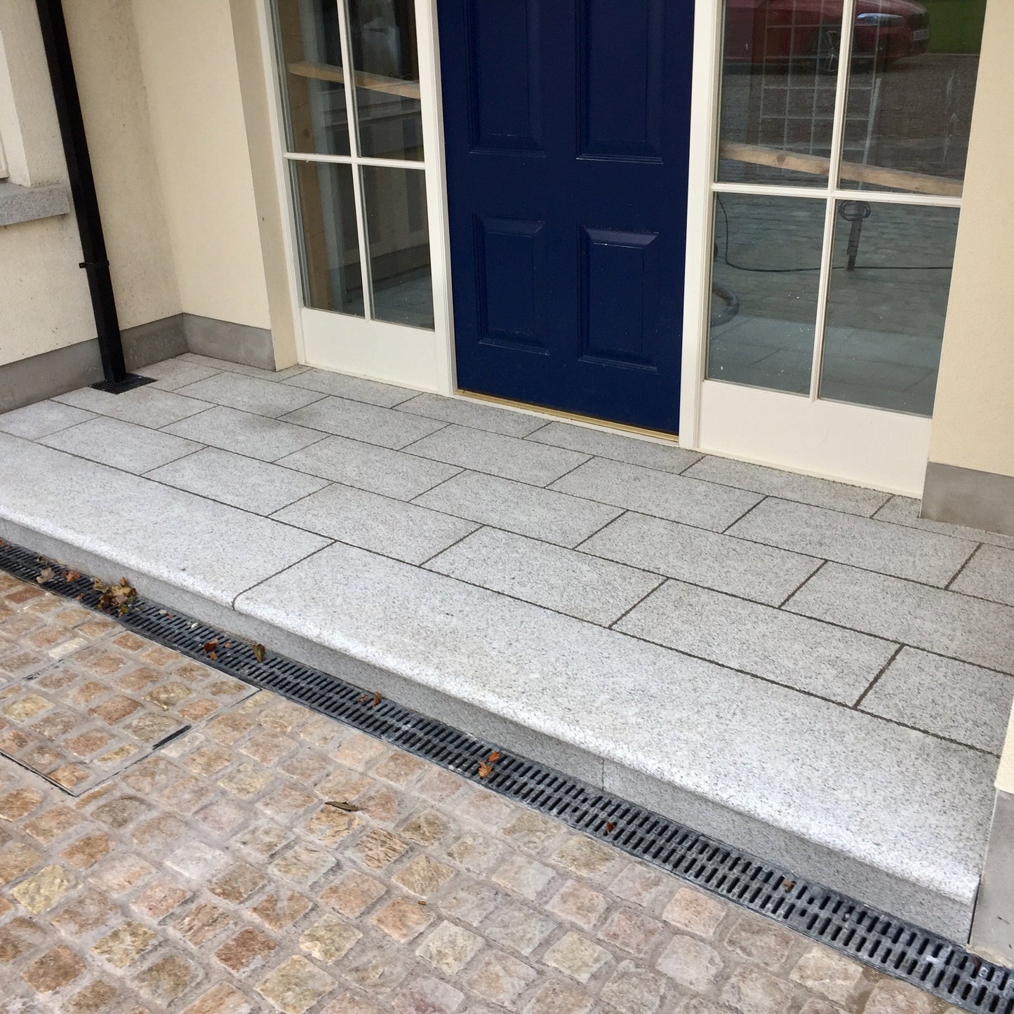 Front entrance with Granite Steps and Flamed Silver Granite Paving in 600 x 300mm Size. 
