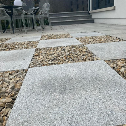 Patio area with unique design featuring Silver Granite Paving Slabs in 600 x 600mm size. 