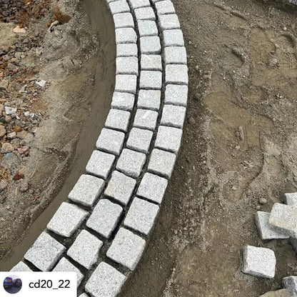 Curved pathway edging being laid using Silver Granite Paving Cobbles in 100 x 100mm size. 