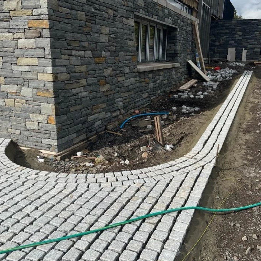 Domestic landscape design featuring Silver Granite Paving Cobbles in 100 x 100mm size. 