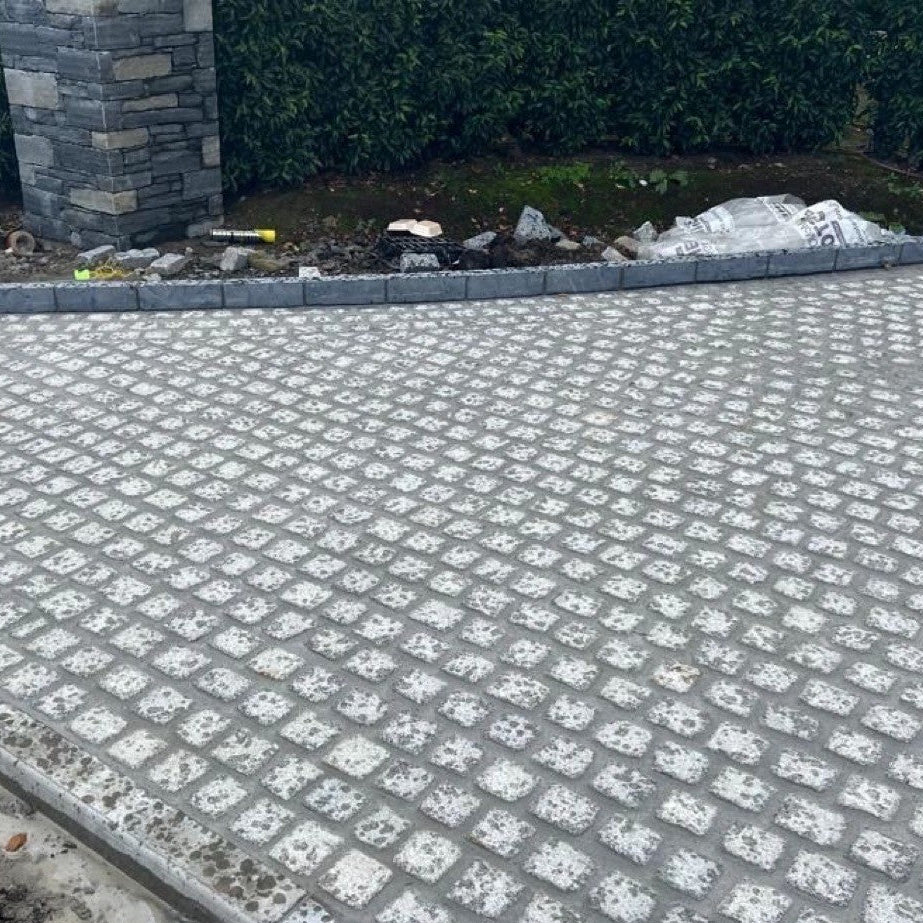 Driveway nearing completion with Silver Granite Paving Cobbles in 100 x 100mm size.