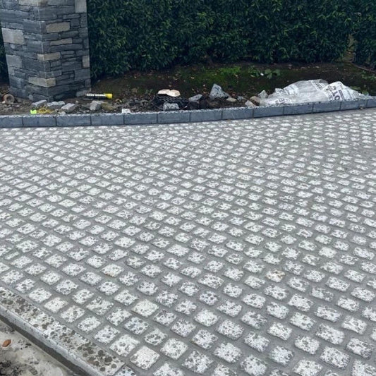 Driveway nearing completion with Silver Granite Paving Cobbles in 100 x 100mm size.