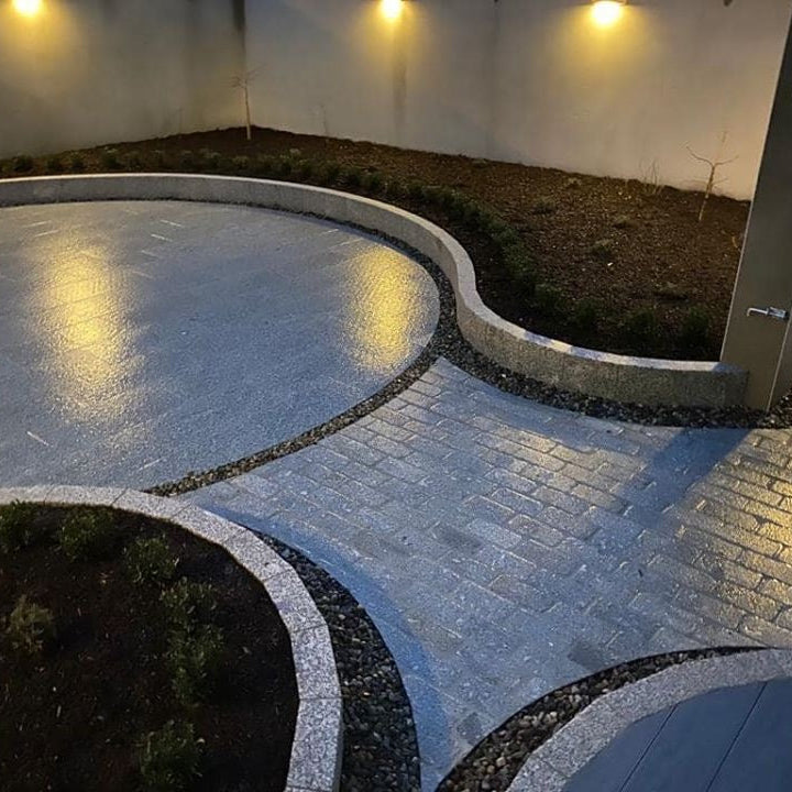 Circular patio area with pathway completed in Silver Granite Cobbles in 200 x 100mm size. 