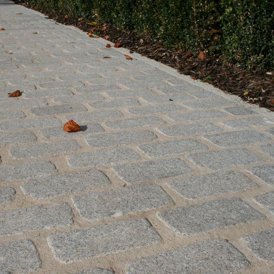 Cobbled pathway made of Silver Granite Paving Cobbles in 200 x 100mm size.