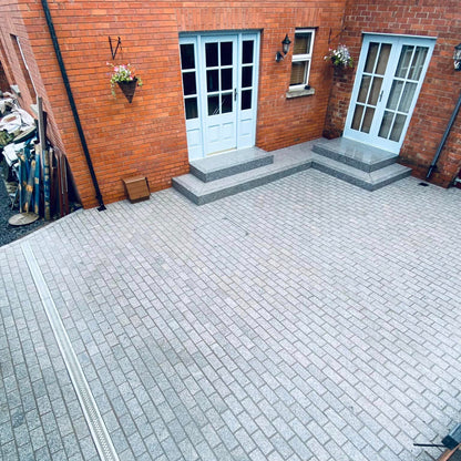 Patio area completed in Sawn Silver Granite Paving Cobbles in 200 x 100mm Size with a flamed finish. 
