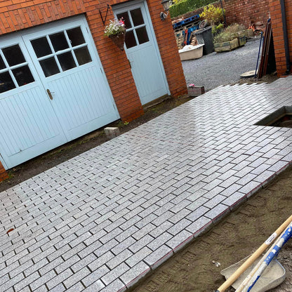 Patio area under construction with Silver Granite Cobbles in 200 x 100mm size. Sawn and flamed finish. 