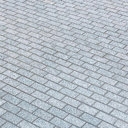 Pattern of Sawn Silver Granite Paving Cobbles in 200 x 100mm size with a flamed finish. 