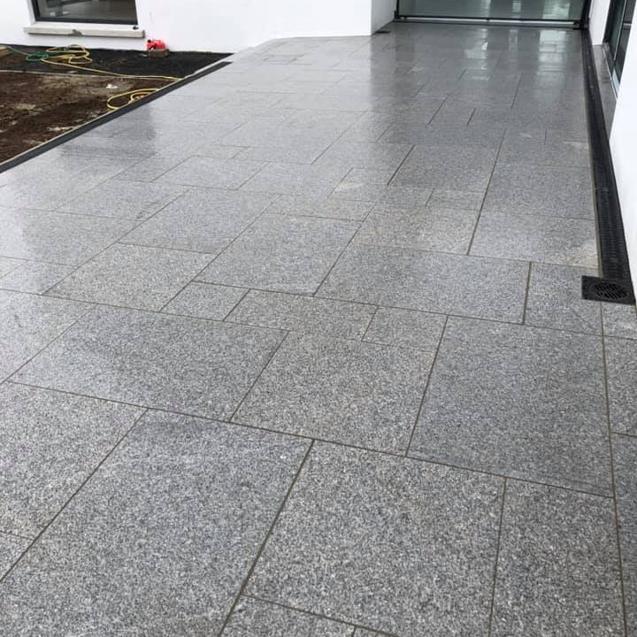 Patio area completed using Silver Granite Paving in mixed sizes. 