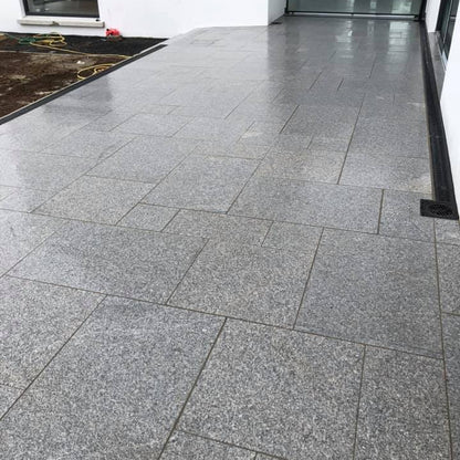 Patio area completed using Silver Granite Paving in mixed sizes. 