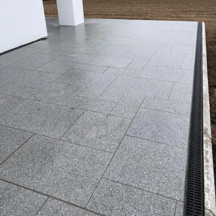 Patio area completed using Silver Granite Paving in mixed sizes. 