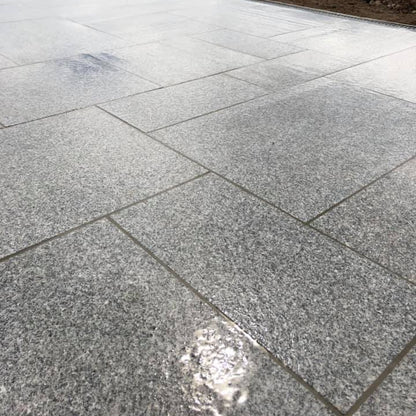 Close up of flamed Silver Granite Paving in mixed patio pack sizes. 