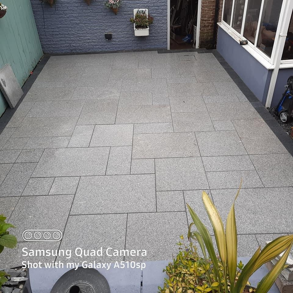 Small patio area completed using Flamed Silver Granite Paving in mixed sizes. 