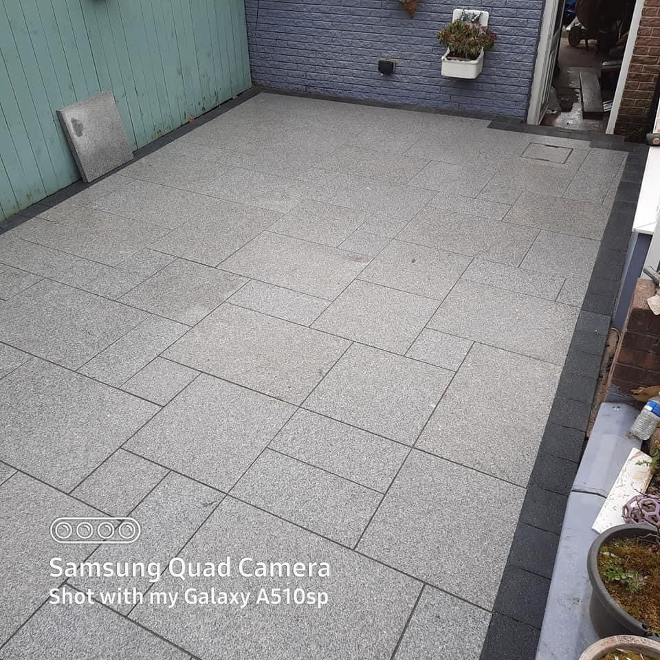 Small patio area completed using Flamed Silver Granite Paving in mixed sizes.  
