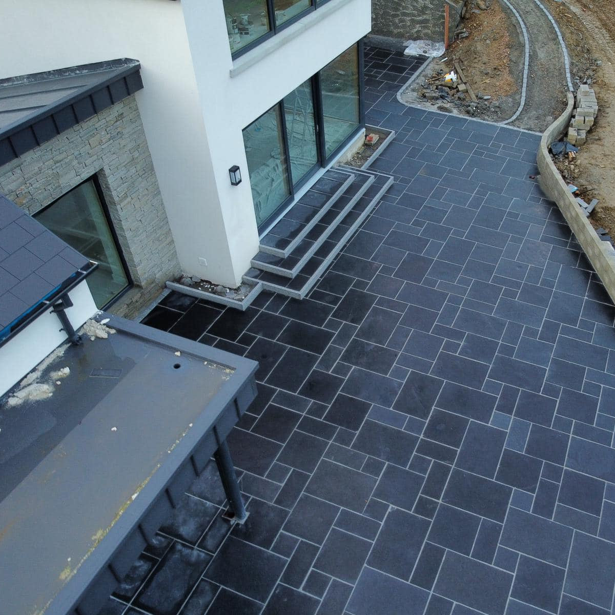Ariel view of large patio area featuring Silver Granite Pin Kerbing. 
