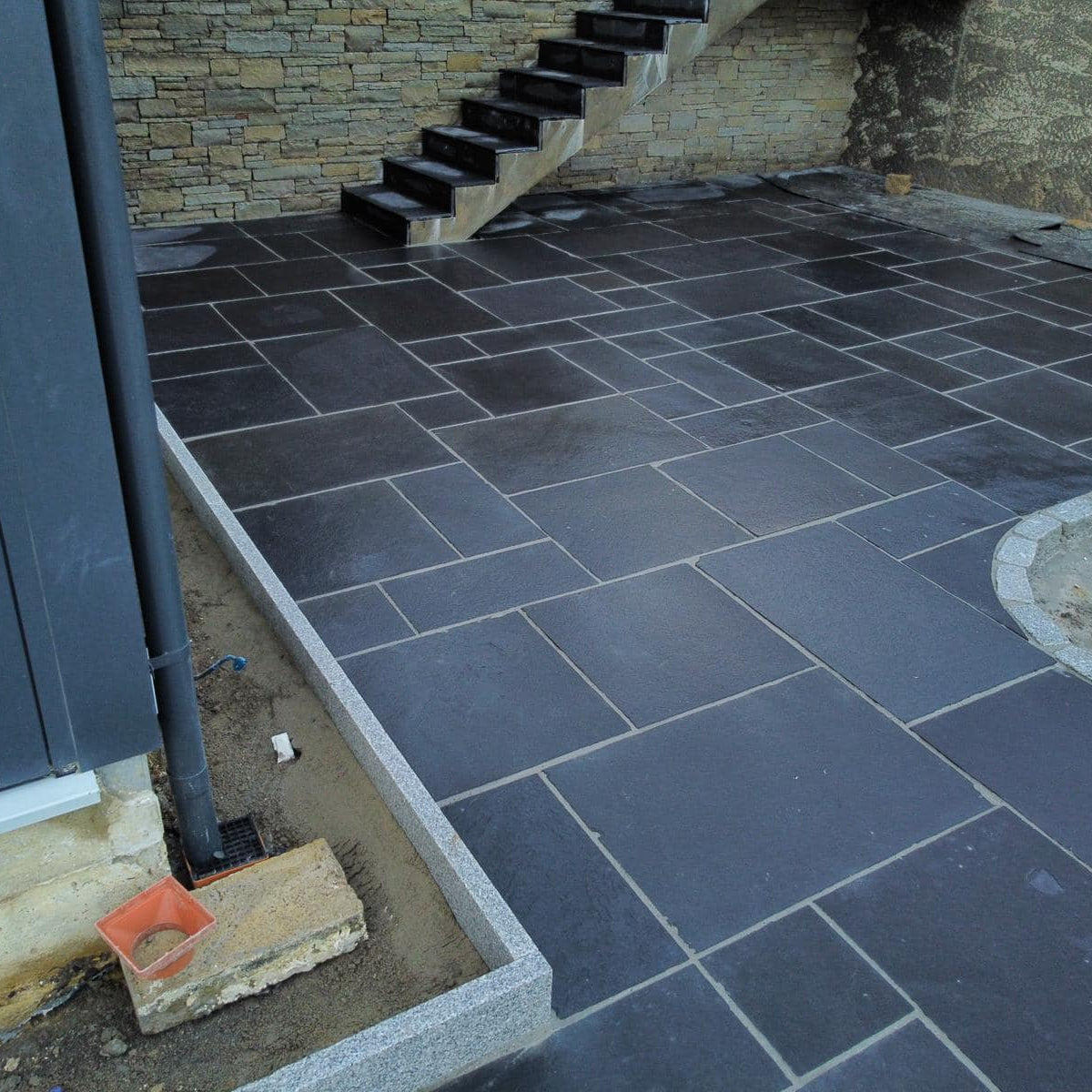 Patio area edging completed using Silver Granite Pin Kerbs. 