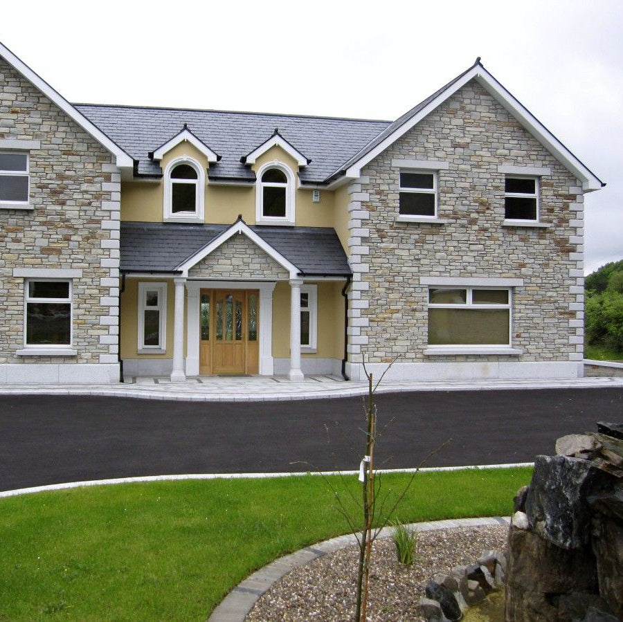 Two storey house with bespoke Silver Granite Portico, Lintels, Sills and Plinth.  
