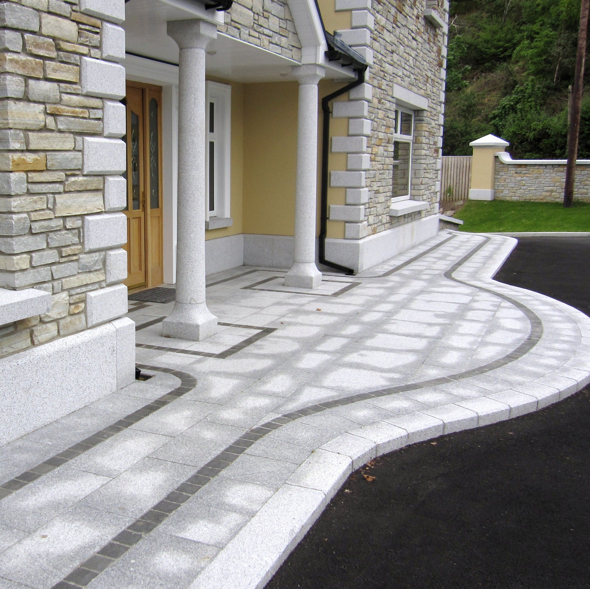 Close up of Silver Granite Portico Columns leading to house entrance. 