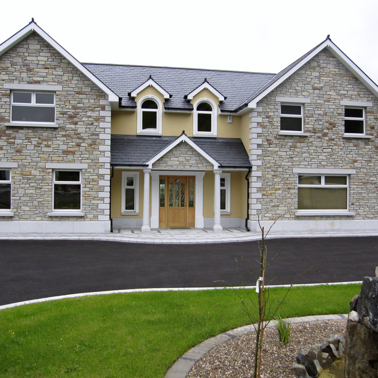 Two storey house with bespoke silver granite portico, Quoins, Lintels and Sills.