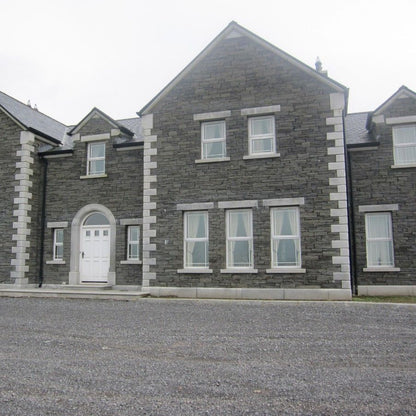 Large stone house featuring bespoke Silver Granite Door Surround, Lintels, Sills, Quoins and Plinth. 