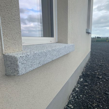 Bespoke Silver Granite Window Sill with a textured finish on a building exterior