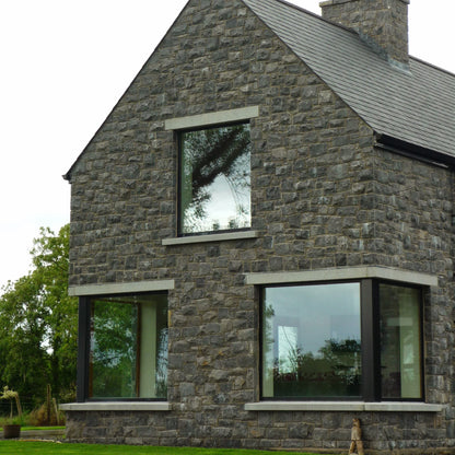 Stone house with bespoke silver granite window Sills and Lintels. 