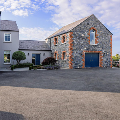 Modern house with stone façade featuring bespoke Silver Granite Sills
